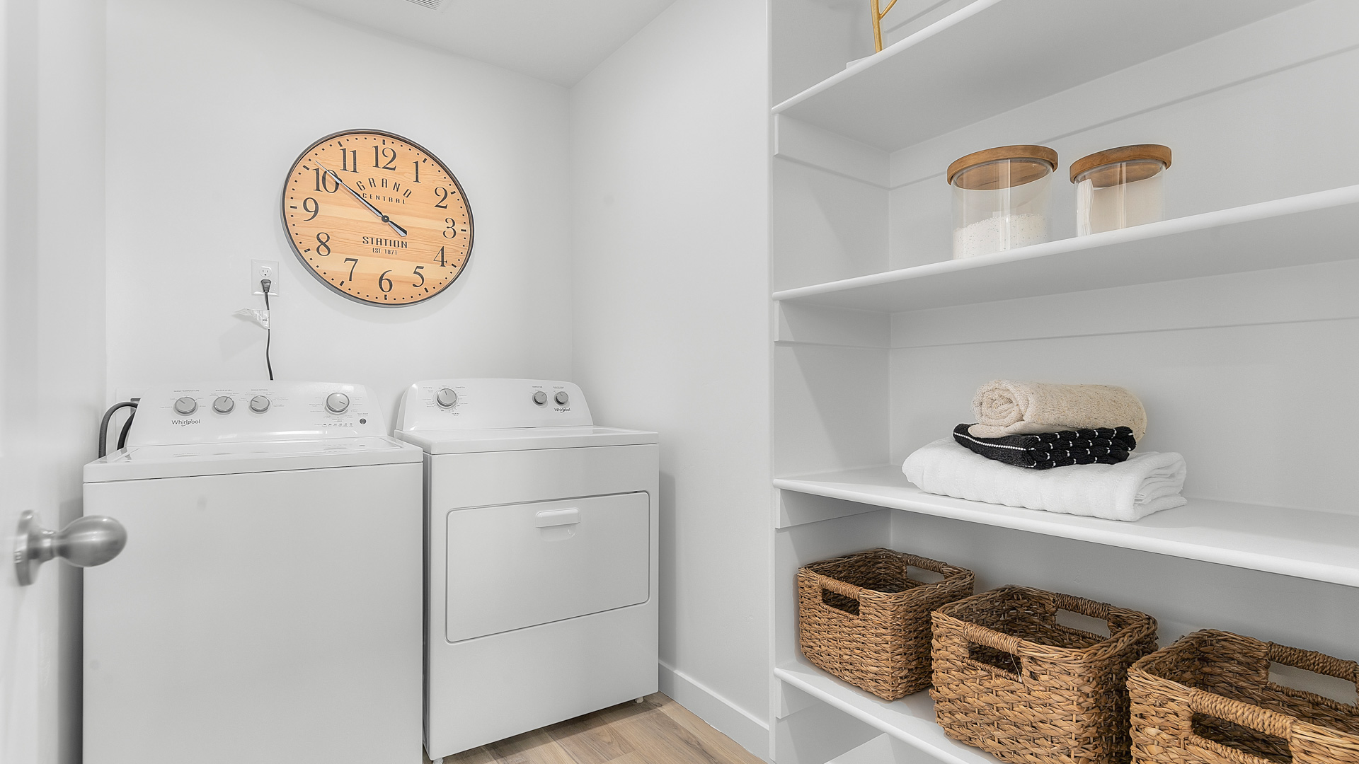 Spacious laundry room with shelving.