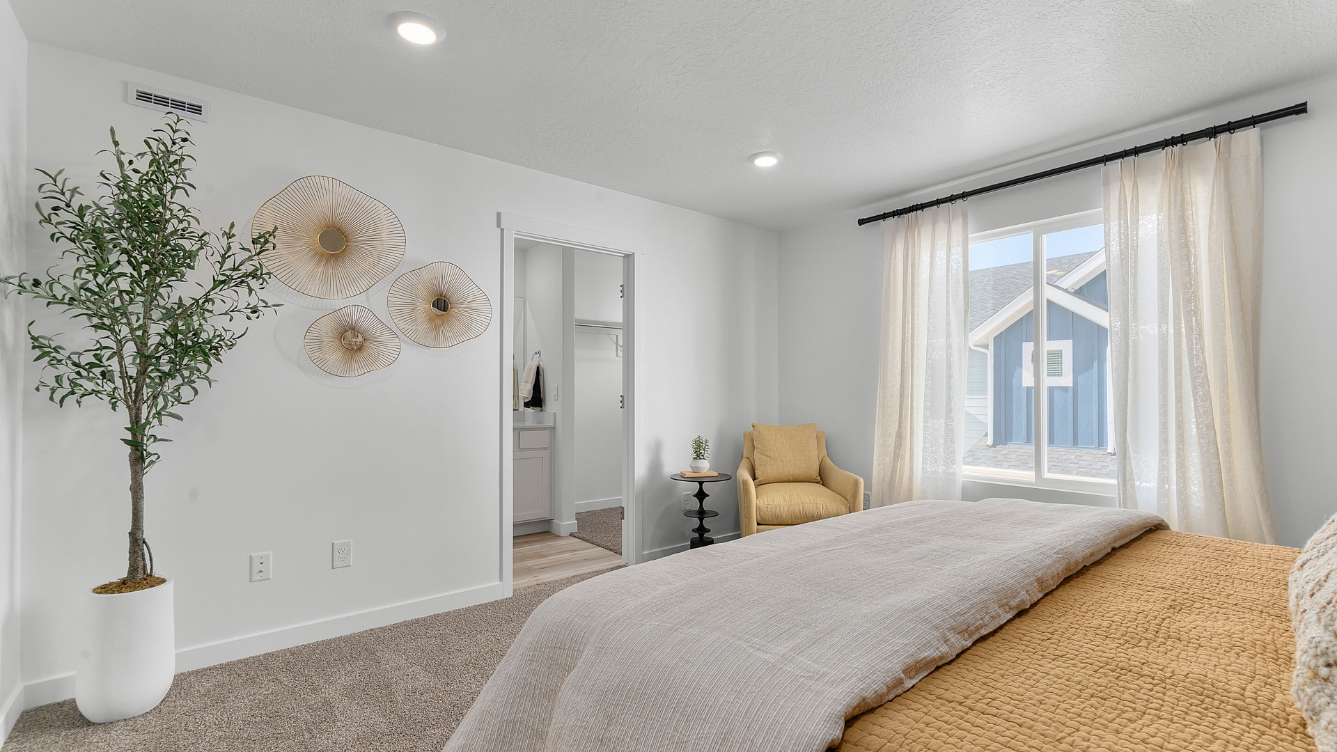 Primary bedroom with large window and beautifully furnished.