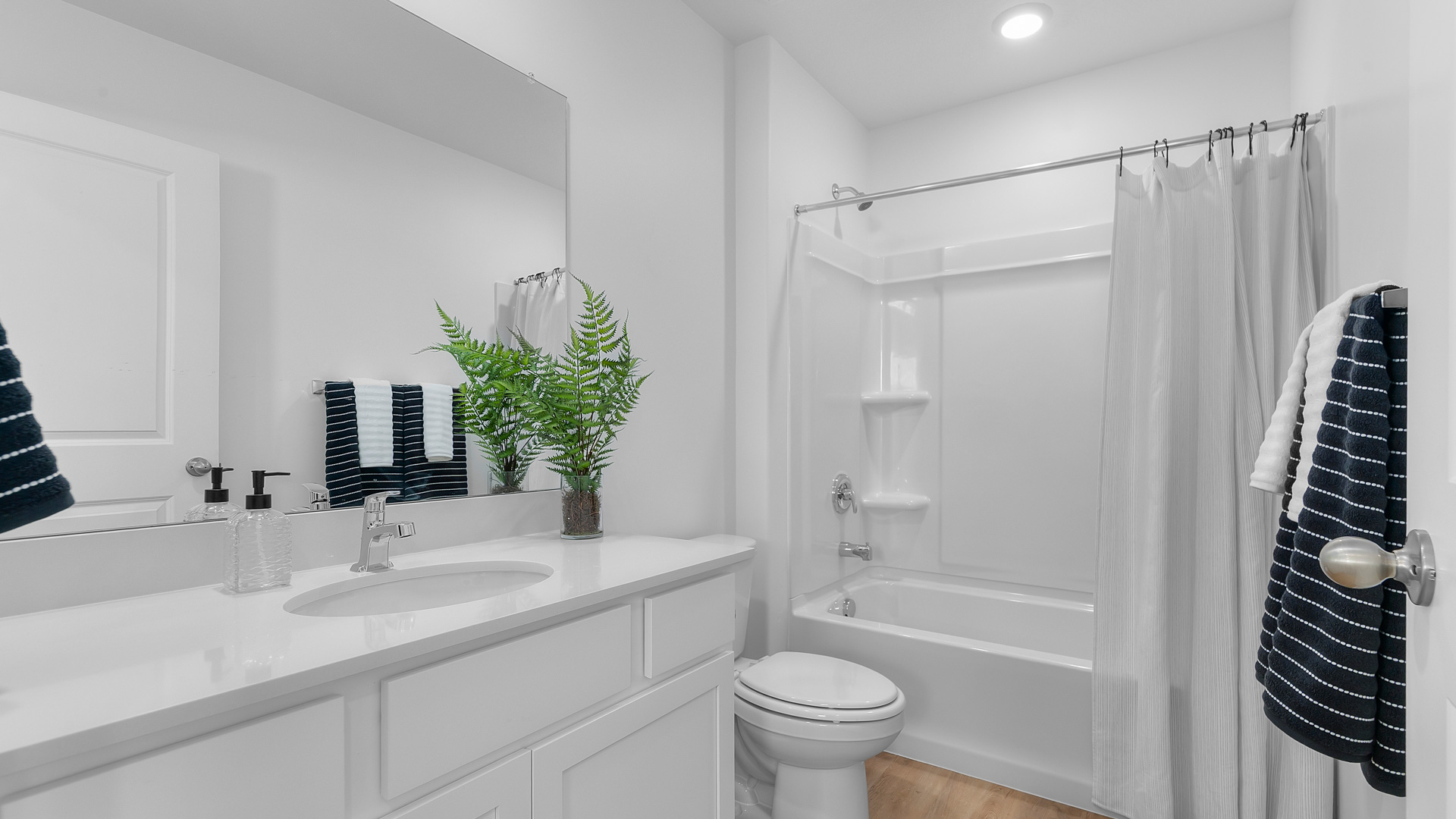 Primary bathroom with shower surround.