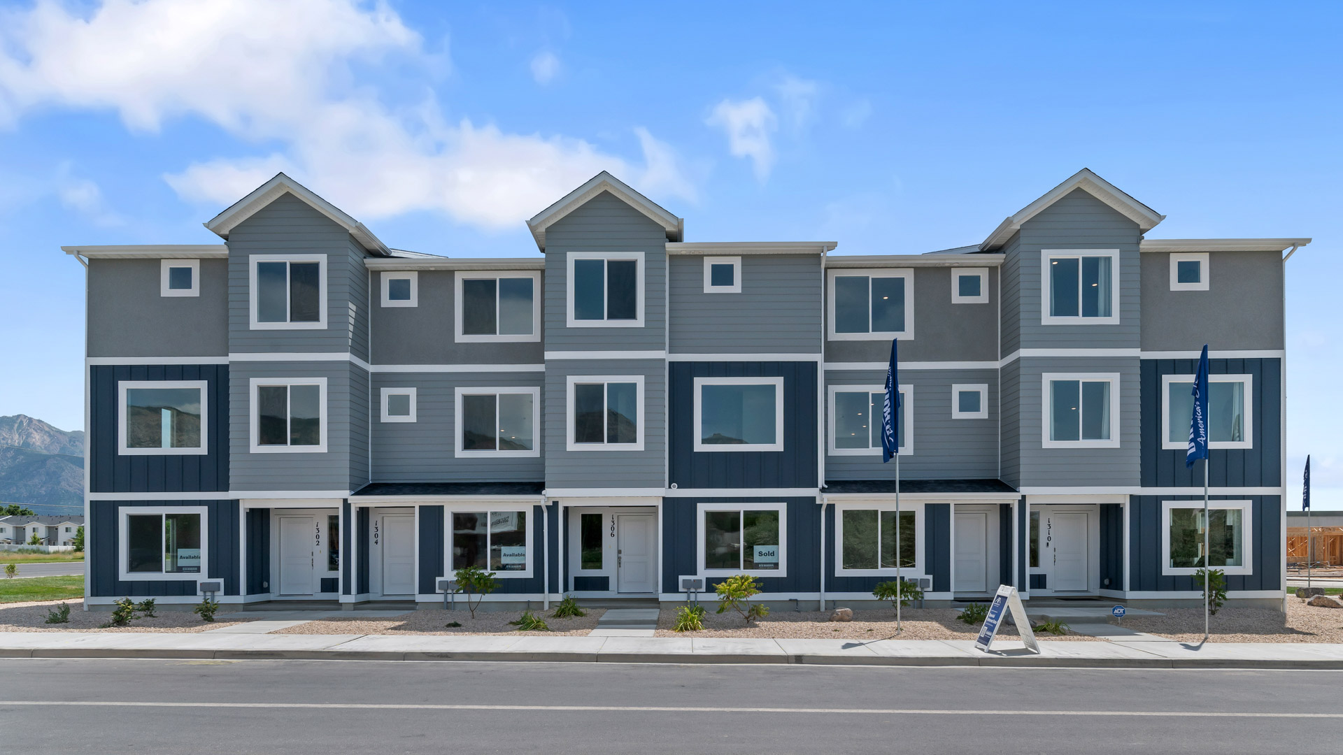 New three-story townhome end-unit with covered porch in Harrisville Utah.