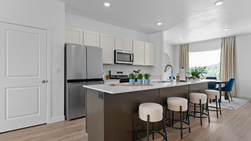 Open-concept kitchen space with kitchen island and appliances.
