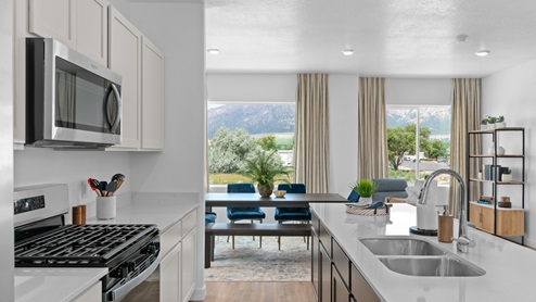 Open-concept kitchen space with kitchen island and appliances.