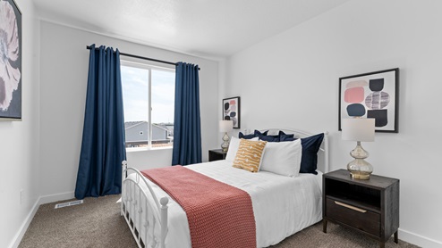 Upstairs bedroom with large window and closet.