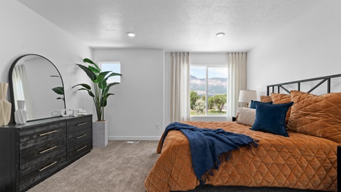 Primary bedroom with large window and square window.
