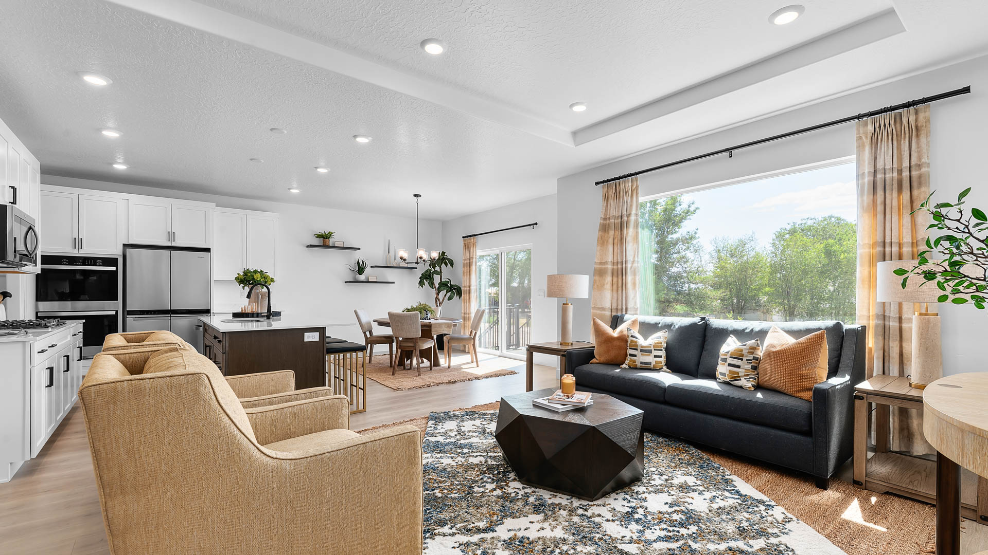 Family room with large window and tray ceilings.