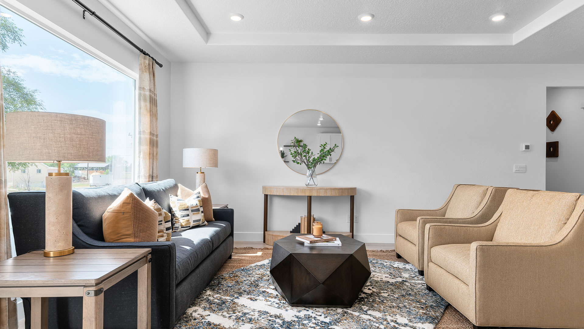 Family room with large window and tray ceilings.