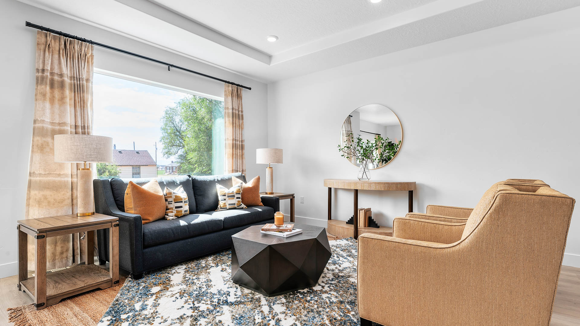 Family room with large window and tray ceilings.