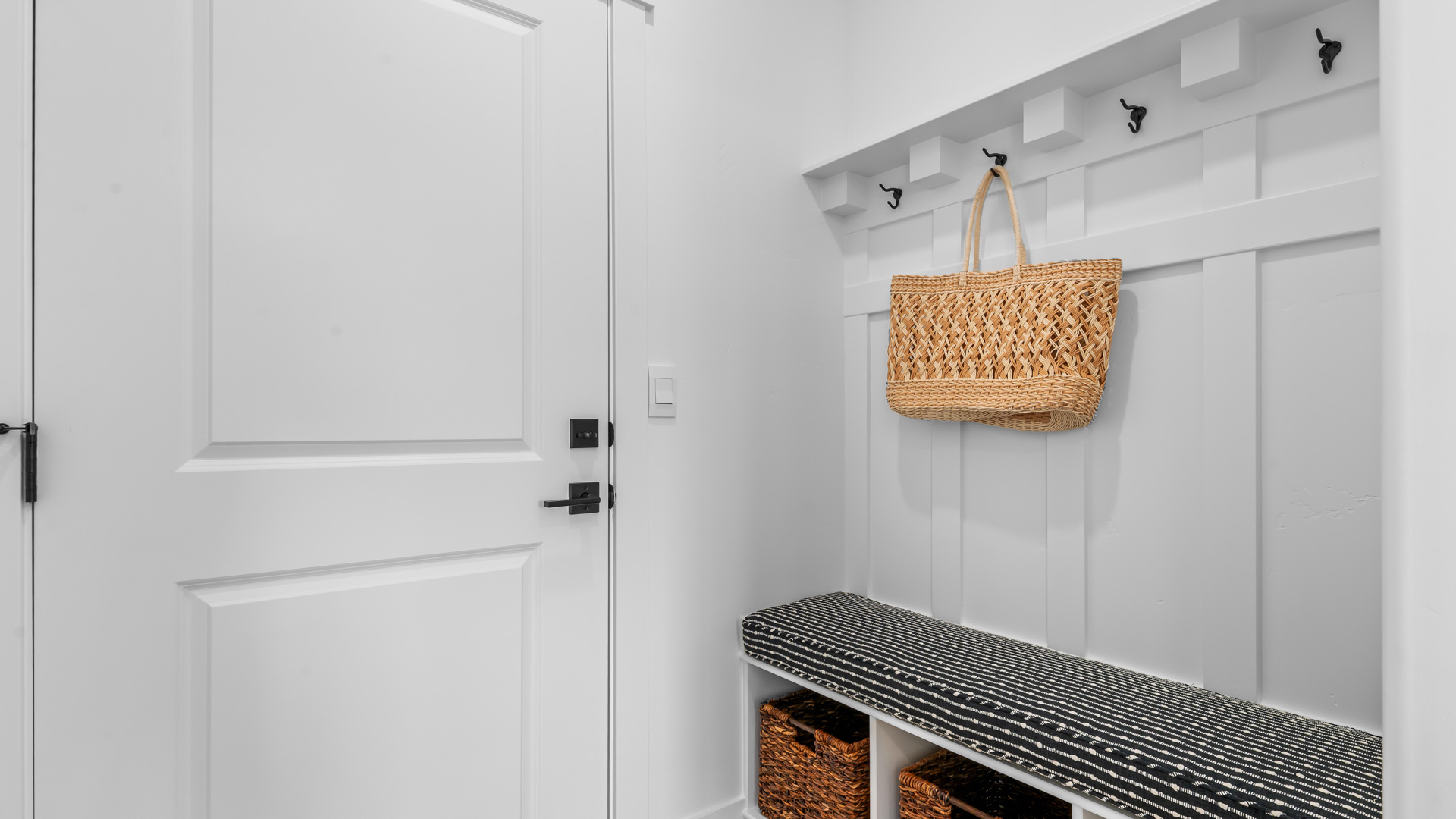 Mud room with mudroom bench and storage space.