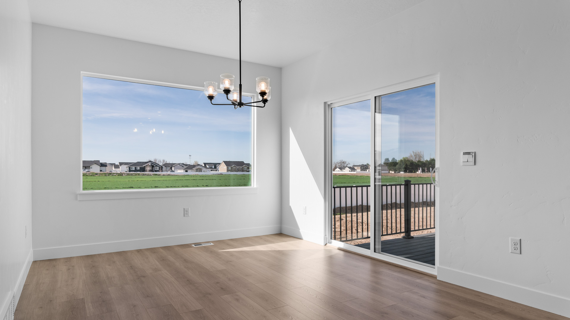 Dining space with large window and patio doors.
