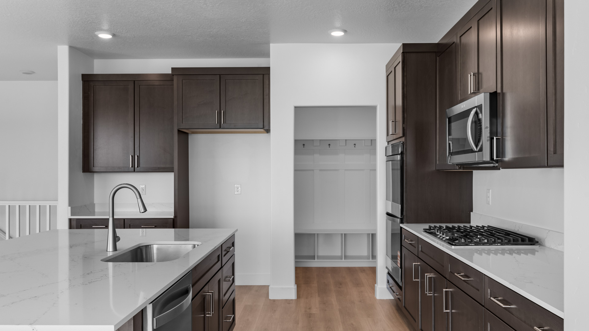 Kitchen with large kitchen island with sink and stainless steel appliances.