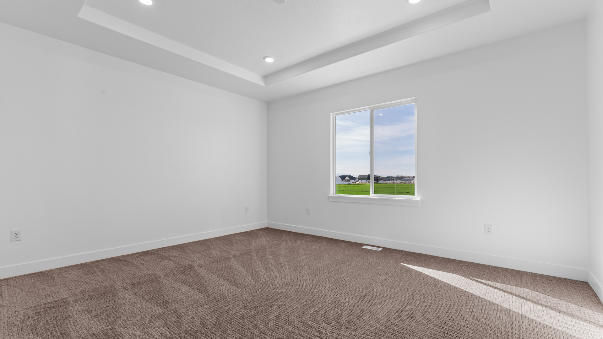 Primary bedroom with tray ceiling.