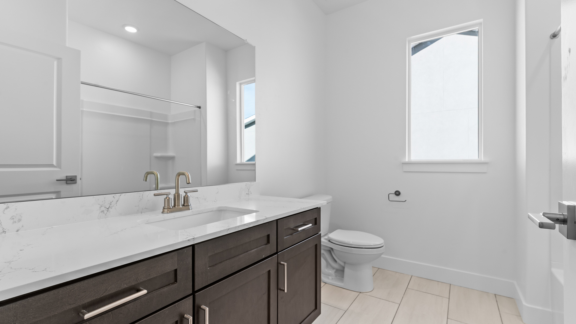 Bathroom with large vanity and shower.