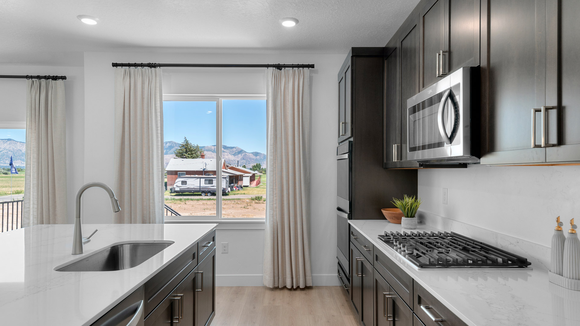 Kitchen with kitchen island and stainless steel appliances.