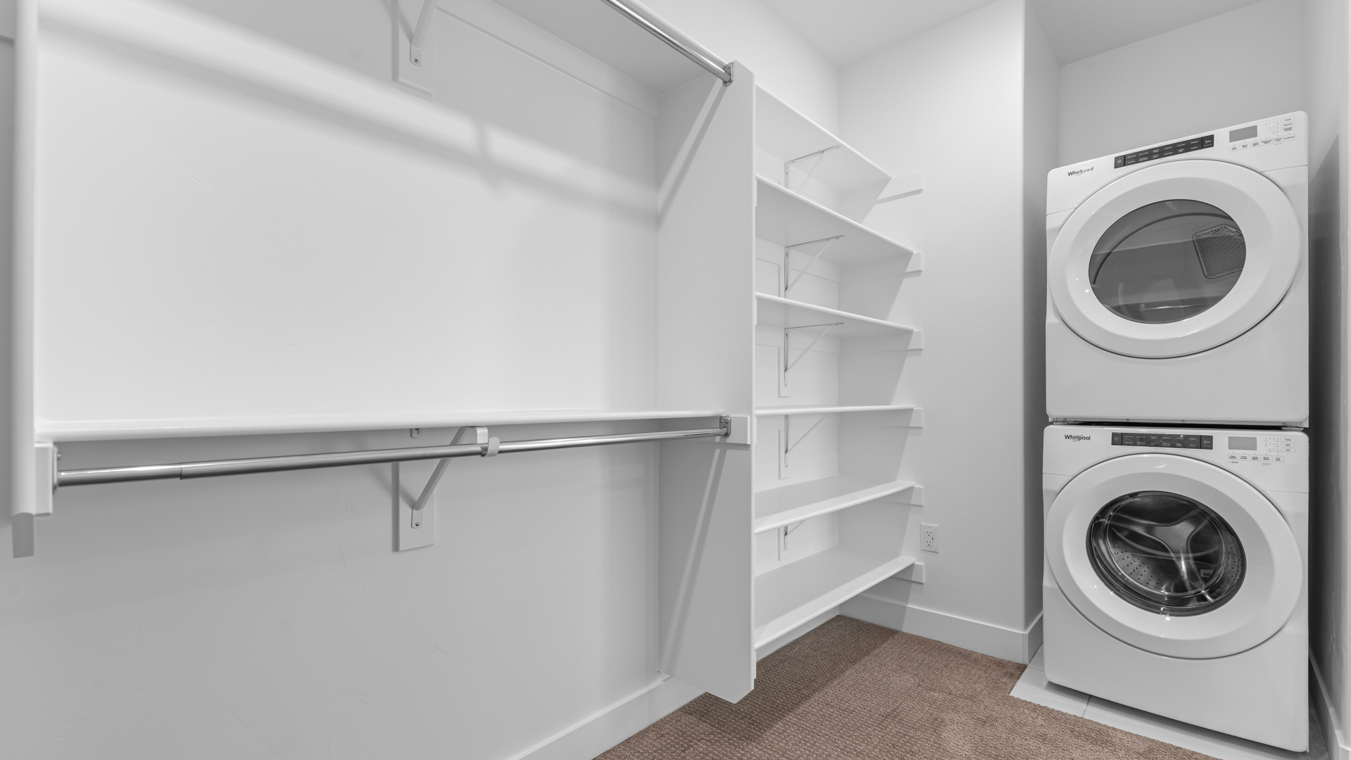 Walk-in closet featuring wash and dryer duo.