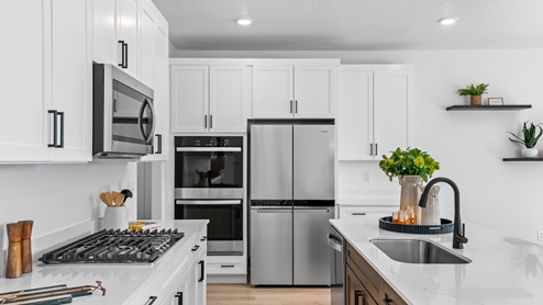 Kitchen with stainless steel appliances and kitchen island.