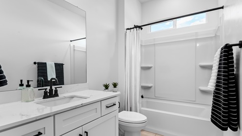 Bathroom with window above shower surround.