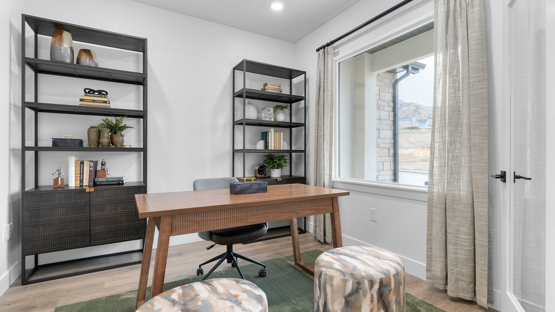 Office space with large window and glass doors.