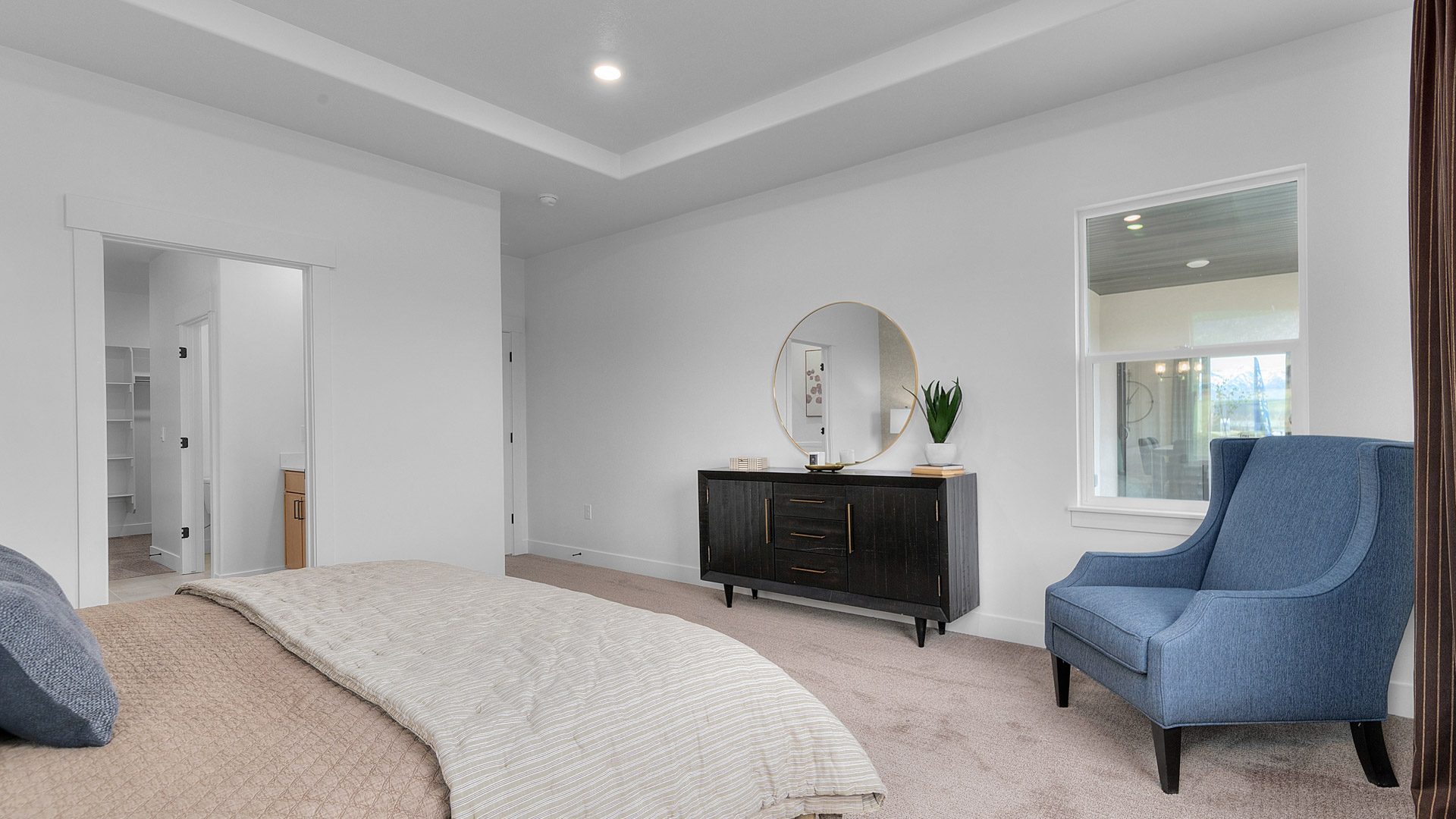 Primary bedroom with large window.