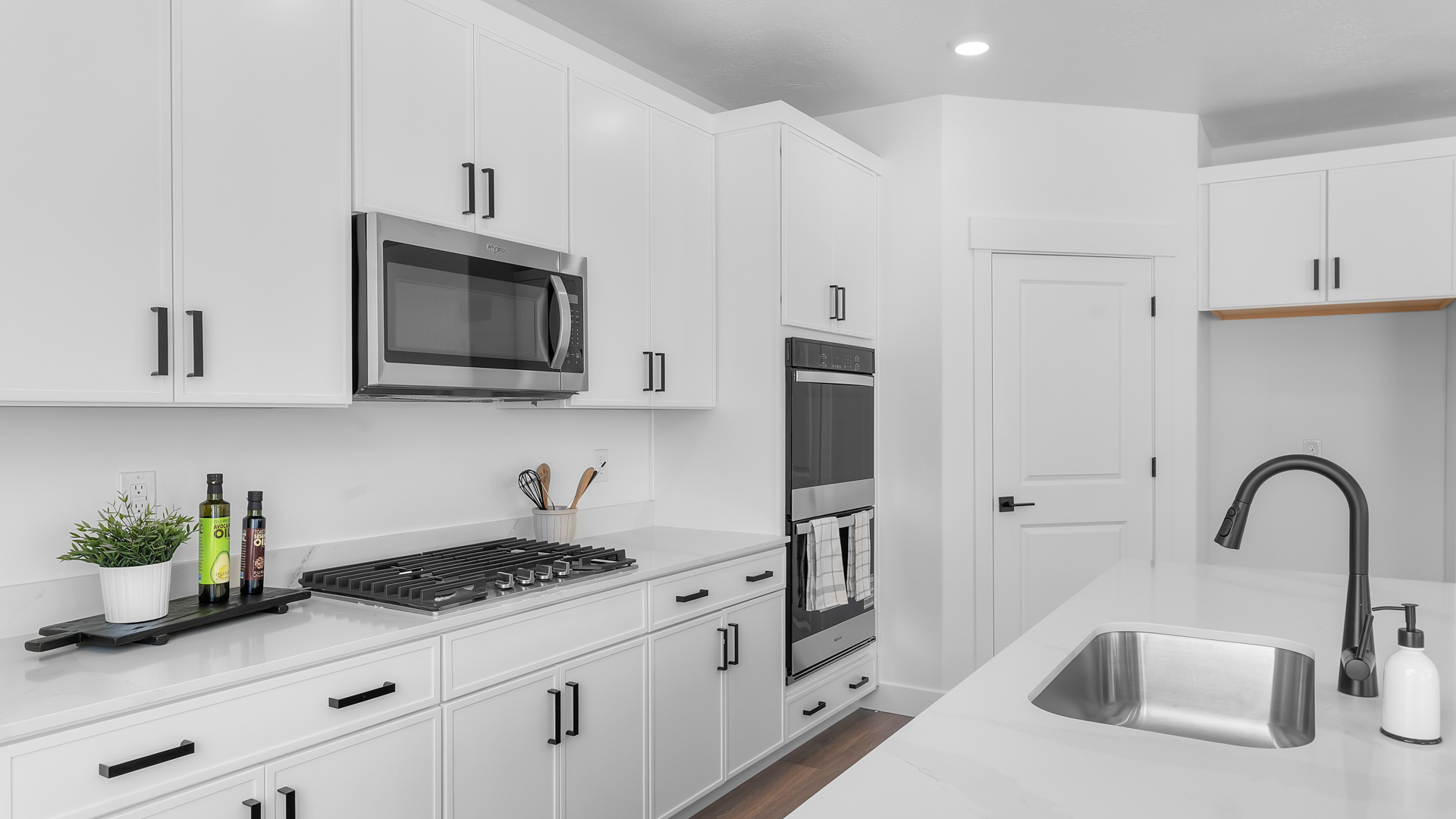 Kitchen with kitchen island and stainless steel appliances.