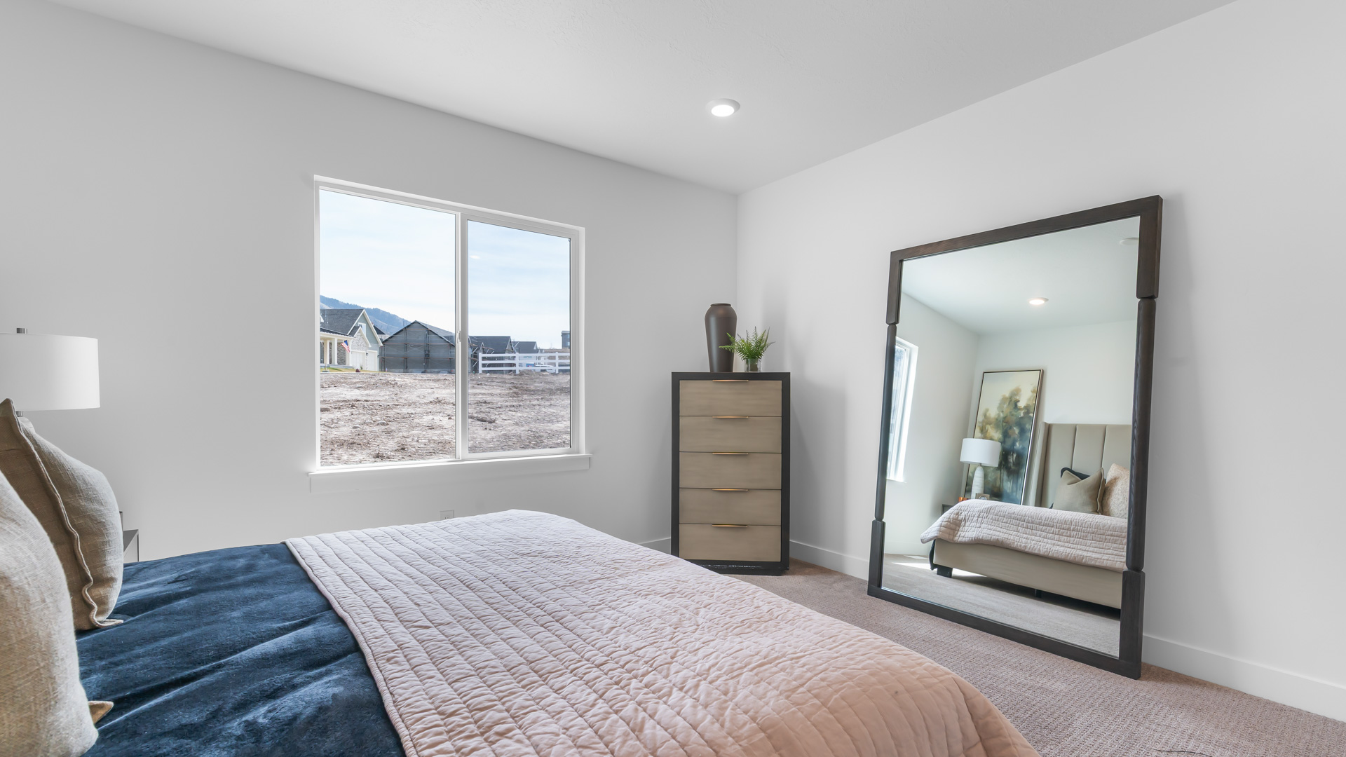 Primary bedroom with large window.