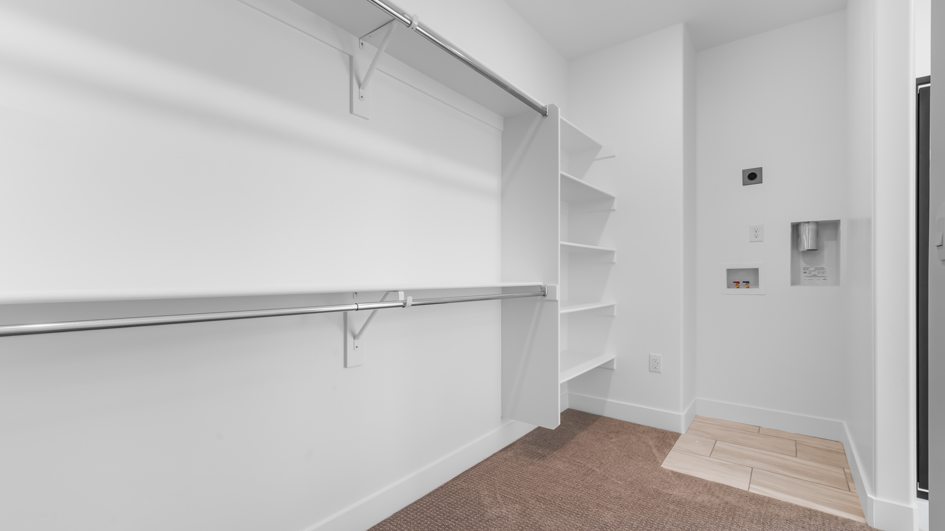 Walk-in closet featuring wash and dryer duo area.