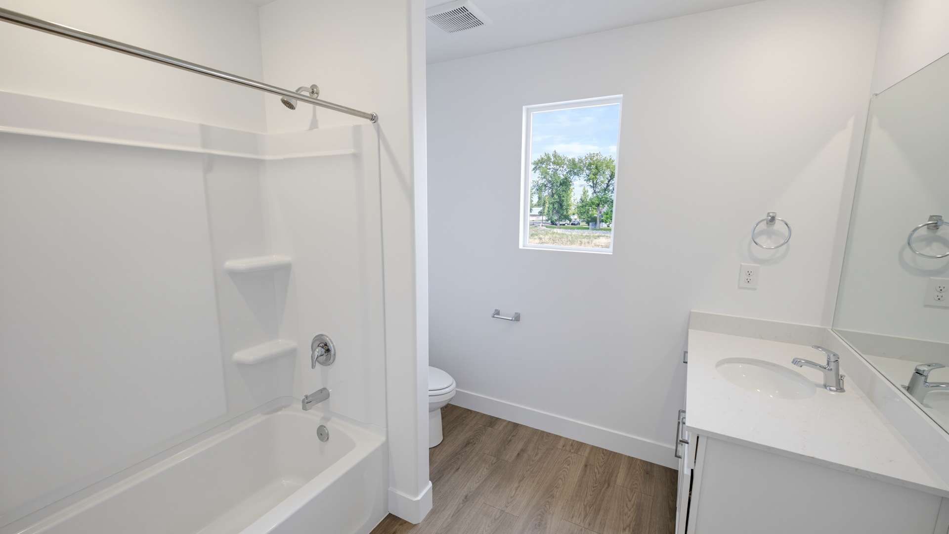 Bathroom with shower surround and window above.