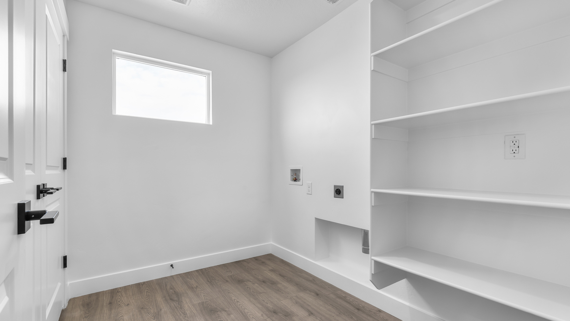Laundry area behind double doors in hallway