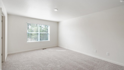 bedroom with a window and carpet flooring