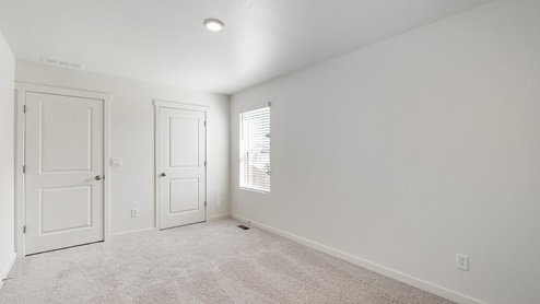 bedroom with a window and carpet flooring