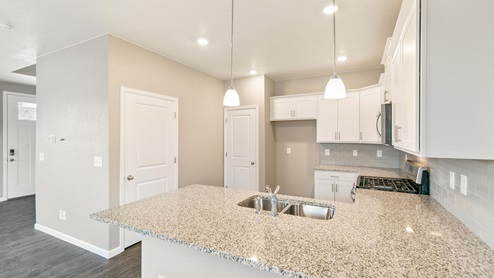 white cabinet kitchen with an islannd