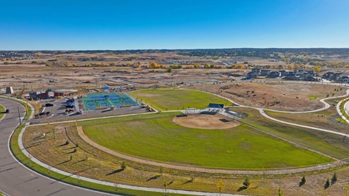 Trails at Crowfoot community by D.R. Horton fields and sport courts connected by walking paths in Parker, Colorado