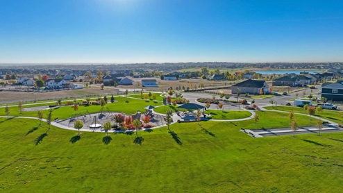 Community playground, gazebo, and bocce ball field interconnected by walkway,
