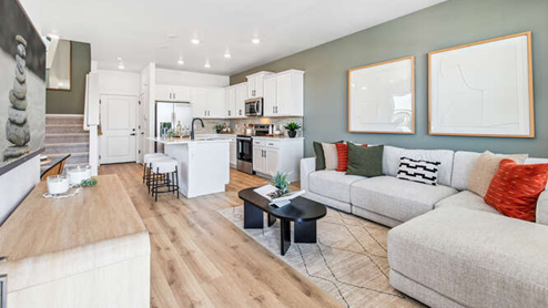Melbourne furnished model home great room with laminate hardwood flooring with kitchen inbackground