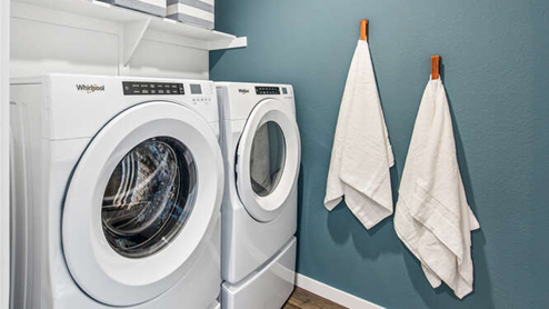 Furnished Muirfield model home laundry room with built in shelf