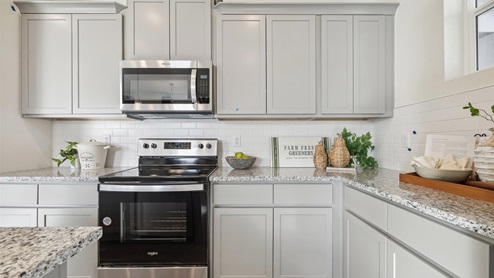 staged gray cabinet kitchen with stainless steel appliances