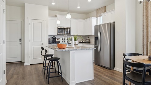 staged white kitchen with stainless steel appliances