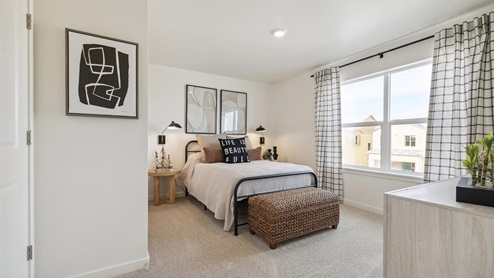 staged bedroom with a window and ceiling light