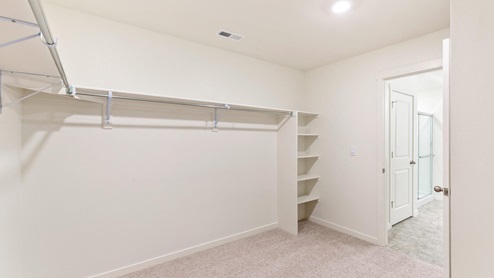 Hennessy Primary Bedroom Walk in Closet at Timberleaf by D.R. Horton