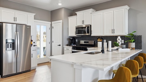 Modern kitchen with quartz countertops at Horizon Upton new home by D.R. Horton in Aurora, Colorado