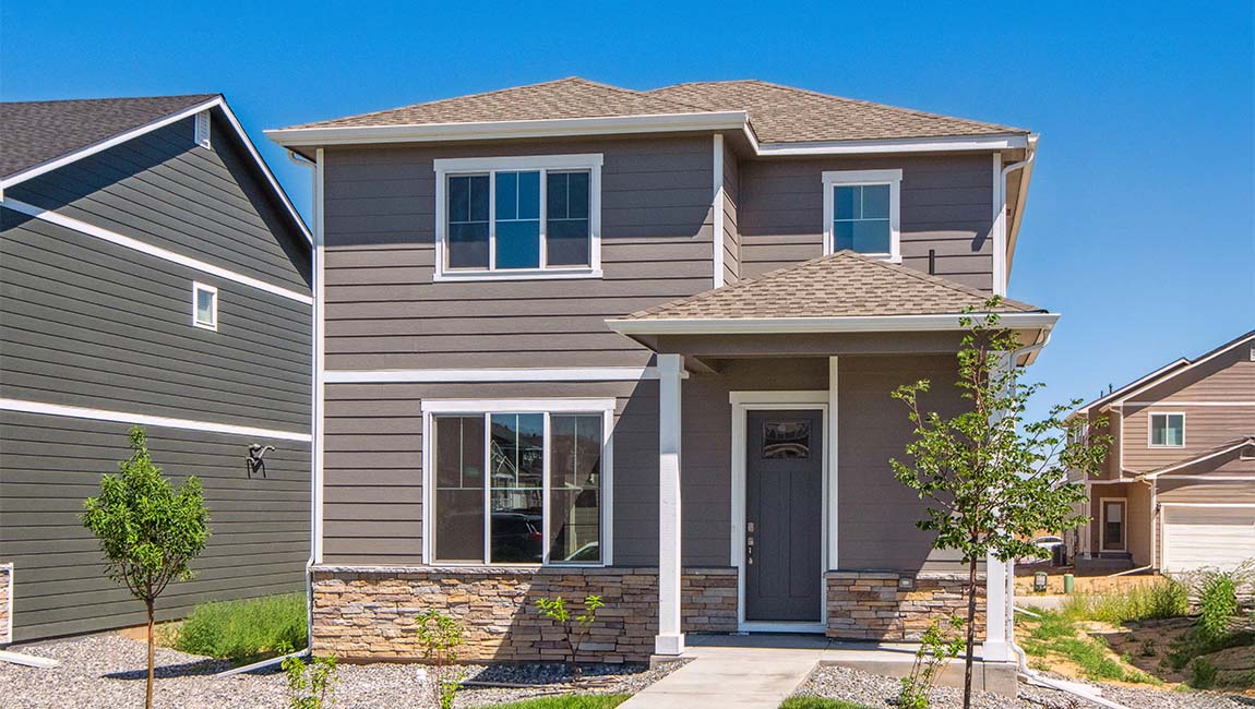 Douglas home exterior displaying a mocha paint color with white trim, gridded windows and low maintenance landscaping