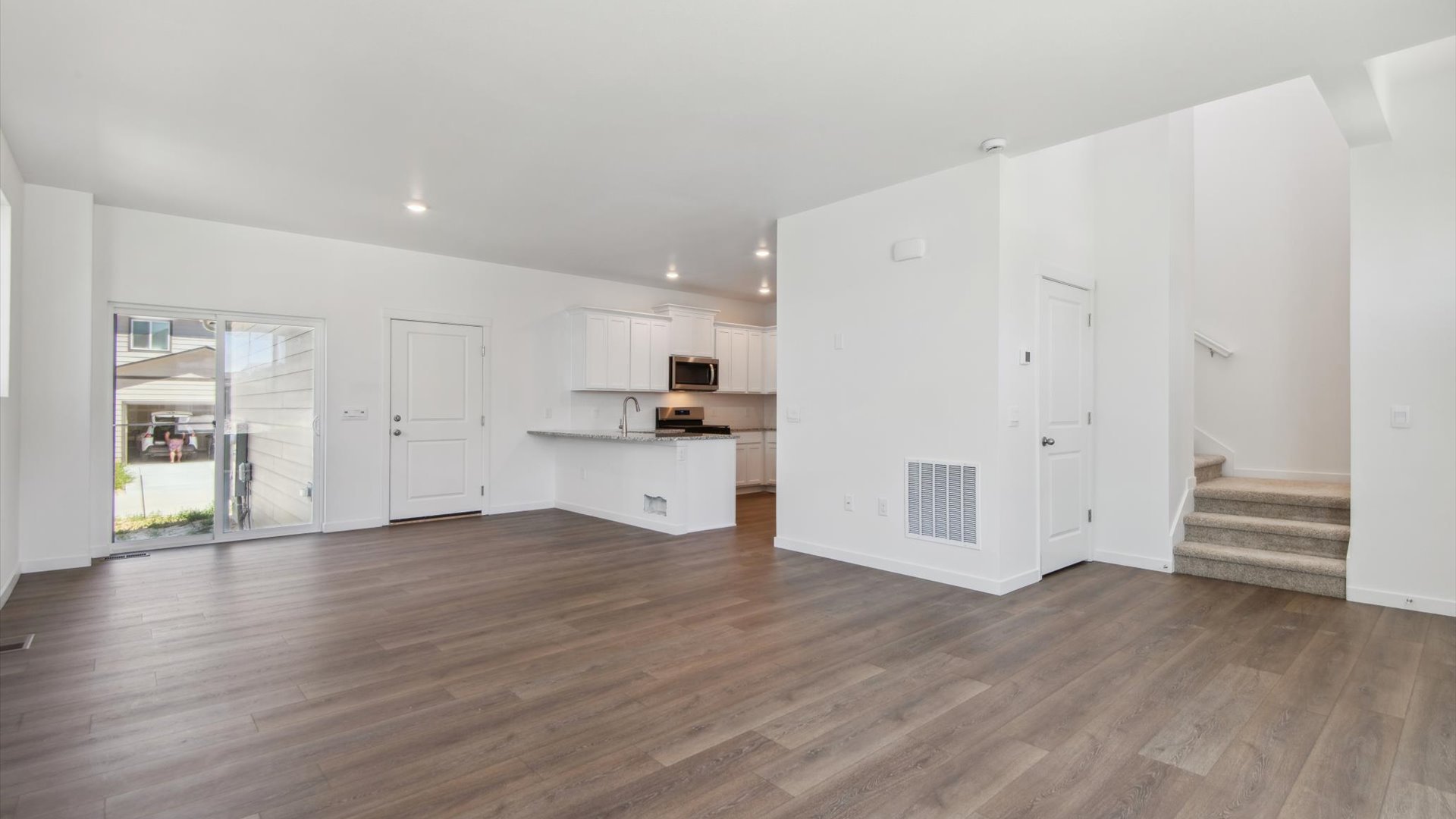 Rotated angle of Douglas floor plan dining room facing kitchen peninsula, showing under-stair storage and stairwell nearby