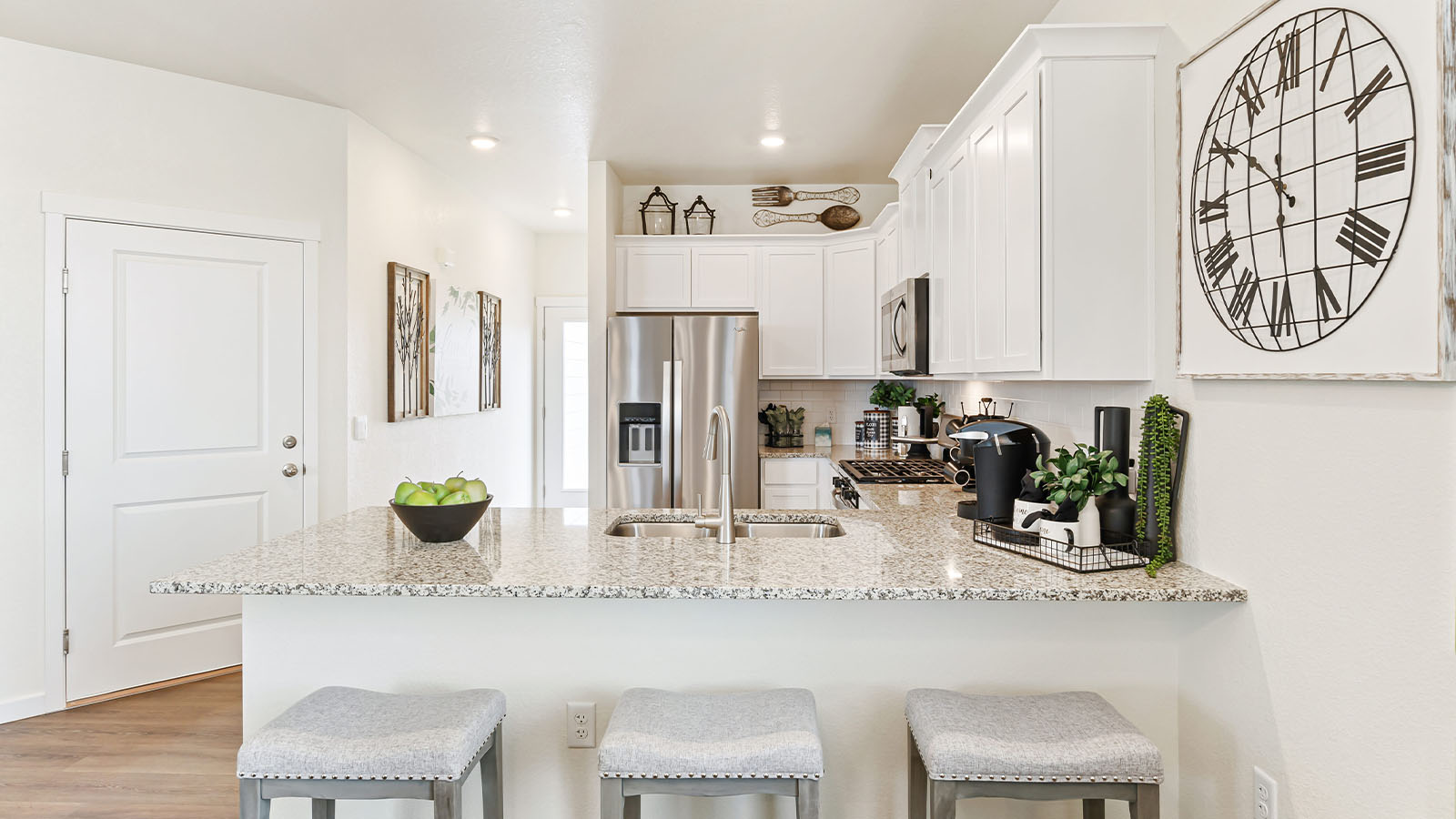 Closeup view of Alamosa model home kitchen peninsula with expansive countertops and brand new crisp white cabinetry