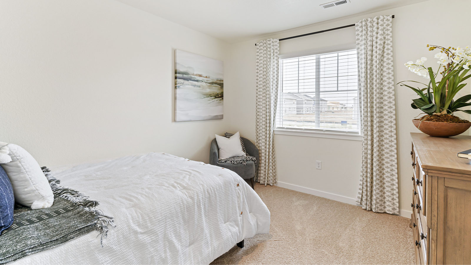 Another secondary bedroom in Horizon Uptown Alamosa floor plan with plush carpeting, gridded windows and sills and LED light
