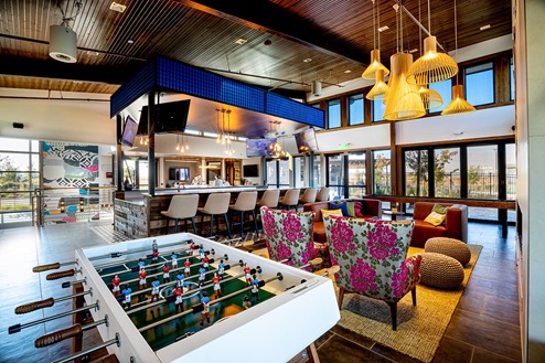 Community loft space with foosball, bar, firplace seating and large windows