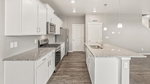 white cabinet kitchen with stainless steel appliances and an island