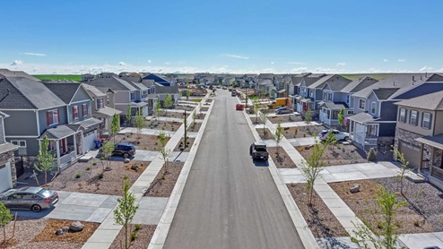 Drone shot down street showing new homes in Aurora, Colorado at Harmony by D.R. Horton