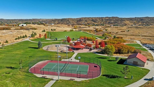 Crystal Valley community amenities including tennis, sport courts, play toys, covered picnic area, and lighted sports fields