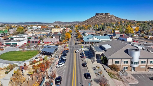 Aerial image of Castle Rock Colorado city amenities, buildings, park and territorial views including iconic rock formation