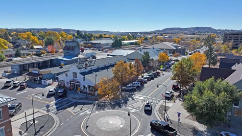 Drone photograph of Castle Rock Colorado area amenities, buildings, shopping area with street parking and roundabout