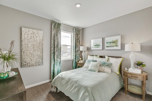 Pine Ridge Henley model home has a main floor bedroom with operable window, plush carpeting and a full bathroom nearby